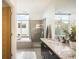Bright bathroom with tiled shower, soaking tub, and double sink vanity at 3220 Zuni St, Denver, CO 80211