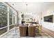 Elegant dining room with a designer chandelier, large windows, and an open view to the kitchen at 3220 Zuni St, Denver, CO 80211