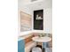 Breakfast nook featuring banquette seating, a round table, and wine rack storage at 3220 Zuni St, Denver, CO 80211