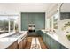 Well-appointed kitchen with designer cabinetry, stainless steel appliances, and hardwood flooring at 3220 Zuni St, Denver, CO 80211
