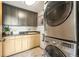 Laundry room equipped with modern stacked washer and dryer and ample cabinet space at 3220 Zuni St, Denver, CO 80211