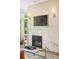 This living room has a marble fireplace with a large mounted TV and modern lighting at 3220 Zuni St, Denver, CO 80211