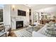 Open-concept living space featuring a modern fireplace, hardwood floors, and an adjacent dining area at 3220 Zuni St, Denver, CO 80211