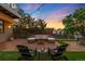 Rooftop patio with modern outdoor furniture, string lights, and vibrant sunset views, perfect for entertaining at 3220 Zuni St, Denver, CO 80211