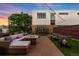 Relax on this rooftop patio featuring a gas firepit, outdoor seating, synthetic grass and charming string lights at 3220 Zuni St, Denver, CO 80211