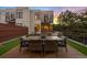 Dine al fresco on this rooftop patio with an outdoor dining table, cozy seating, and synthetic grass at 3220 Zuni St, Denver, CO 80211
