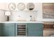 Stylish wet bar featuring a wine fridge, marble backsplash, and elegant gold accents at 3220 Zuni St, Denver, CO 80211