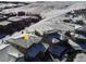 Aerial view of house and neighborhood in snow at 9724 Cantabria Pt, Lone Tree, CO 80124