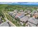 An aerial view showcases a suburban community nestled near rolling hills and mountains on a cloudy day at 9724 Cantabria Pt, Lone Tree, CO 80124