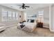 Serene bedroom with a king-size bed, window seating, and plenty of natural light at 9724 Cantabria Pt, Lone Tree, CO 80124