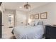 Bright bedroom with a comfortable bed, classic ceiling fan, and attached bathroom at 9724 Cantabria Pt, Lone Tree, CO 80124