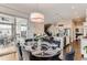 Bright dining room with a stylish round table, velvet chairs, and access to an outdoor patio space at 9724 Cantabria Pt, Lone Tree, CO 80124