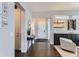 Entryway featuring hardwood floors, neutral decor, a decorative table, and a view into the living space at 9724 Cantabria Pt, Lone Tree, CO 80124