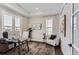 Home office with built-in shelving and plenty of natural light at 9724 Cantabria Pt, Lone Tree, CO 80124