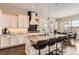 Modern kitchen featuring a large island and white cabinetry at 9724 Cantabria Pt, Lone Tree, CO 80124