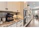 This kitchen features granite countertops, built-in appliances, and ample storage space in the stylish cabinetry at 9724 Cantabria Pt, Lone Tree, CO 80124