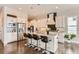 Bright kitchen boasts an island, stainless steel appliances, and white cabinets at 9724 Cantabria Pt, Lone Tree, CO 80124