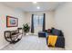 Cozy living room with plush carpeting, natural light from a window, and comfortable seating at 9724 Cantabria Pt, Lone Tree, CO 80124