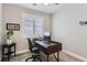 Home office with a sleek desk, comfortable chair, and natural light from shuttered window at 9724 Cantabria Pt, Lone Tree, CO 80124