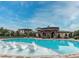 Community pool with lounge chairs and a pergola at 9724 Cantabria Pt, Lone Tree, CO 80124