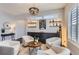 Inviting sitting area featuring neutral-toned chairs, a round table, and a stylish display with lighted shelving at 9724 Cantabria Pt, Lone Tree, CO 80124