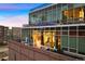 Exterior view of modern condo with glass facade and brick base at 1143 Auraria Pkwy # 402, Denver, CO 80204