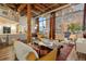 Spacious living room with exposed beams, hardwood floors, and large windows at 1143 Auraria Pkwy # 402, Denver, CO 80204