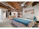 Spacious loft bedroom with exposed beams and large windows at 1143 Auraria Pkwy # 402, Denver, CO 80204