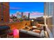 Rooftop patio with city views, comfortable seating, and fire pit at 1143 Auraria Pkwy # 402, Denver, CO 80204