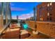 Spacious rooftop patio with city views and a built in fire pit at 1143 Auraria Pkwy # 402, Denver, CO 80204