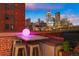 Urban patio with city skyline views, seating area, and fire pit at 1143 Auraria Pkwy # 402, Denver, CO 80204