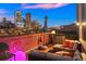 City views from a rooftop deck with seating and a fire pit at 1143 Auraria Pkwy # 402, Denver, CO 80204