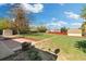 Expansive backyard with a brick patio, mature trees, storage shed, and a lush, green lawn at 3137 S Glencoe St, Denver, CO 80222