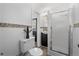 Bright bathroom featuring a shower, dark vanity, and stylish mosaic tile accents at 3137 S Glencoe St, Denver, CO 80222