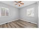 A bright bedroom with neutral walls features wood-look floors, a ceiling fan, and large windows at 3137 S Glencoe St, Denver, CO 80222