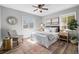 A lovely bedroom features neutral walls, wood-look floors, a ceiling fan, and plentiful natural light at 3137 S Glencoe St, Denver, CO 80222