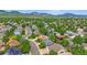 Scenic neighborhood shot surrounded by mature trees and distant mountain views at 12229 W Berry Ave, Littleton, CO 80127