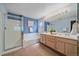 Bathroom featuring a double vanity, bathtub, and separate glass-enclosed shower at 12229 W Berry Ave, Littleton, CO 80127