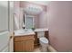 A well-maintained half-bathroom with a traditional design, offering convenience and style at 12229 W Berry Ave, Littleton, CO 80127