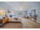 Large bedroom with a vaulted ceiling, ceiling fan, carpeted floor, and natural light at 12229 W Berry Ave, Littleton, CO 80127