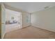 Inviting carpeted bedroom adjacent to living room, offering privacy and convenience at 12229 W Berry Ave, Littleton, CO 80127