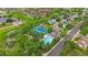 Wide aerial shot capturing the community pool and tennis courts, with green spaces around at 12229 W Berry Ave, Littleton, CO 80127