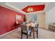 Elegant dining room featuring a unique ceiling design, carpet floors, and a stylish light fixture at 12229 W Berry Ave, Littleton, CO 80127