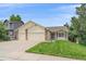 Inviting home featuring an attached two-car garage, well-maintained lawn, and charming curb appeal at 12229 W Berry Ave, Littleton, CO 80127