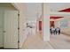 Bright foyer featuring neutral tile floors leading to a cozy living room and elegant dining area at 12229 W Berry Ave, Littleton, CO 80127