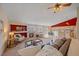 Bright living room featuring a fireplace, comfortable seating, and an open layout to the kitchen at 12229 W Berry Ave, Littleton, CO 80127