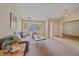 Cozy living room with bay windows, a plush sofa, and a glimpse of the tiled entryway at 12229 W Berry Ave, Littleton, CO 80127