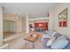 Spacious living area with views of the dining room, neutral paint, and comfortable furnishings at 12229 W Berry Ave, Littleton, CO 80127