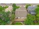 Aerial view showcasing the rear of the home with the back patio and a landscaped backyard at 12229 W Berry Ave, Littleton, CO 80127