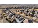 A neighborhood with a green space including two cars parked in front of the house with a mountain view in the background at 15753 E Indian Brook Cir, Parker, CO 80134